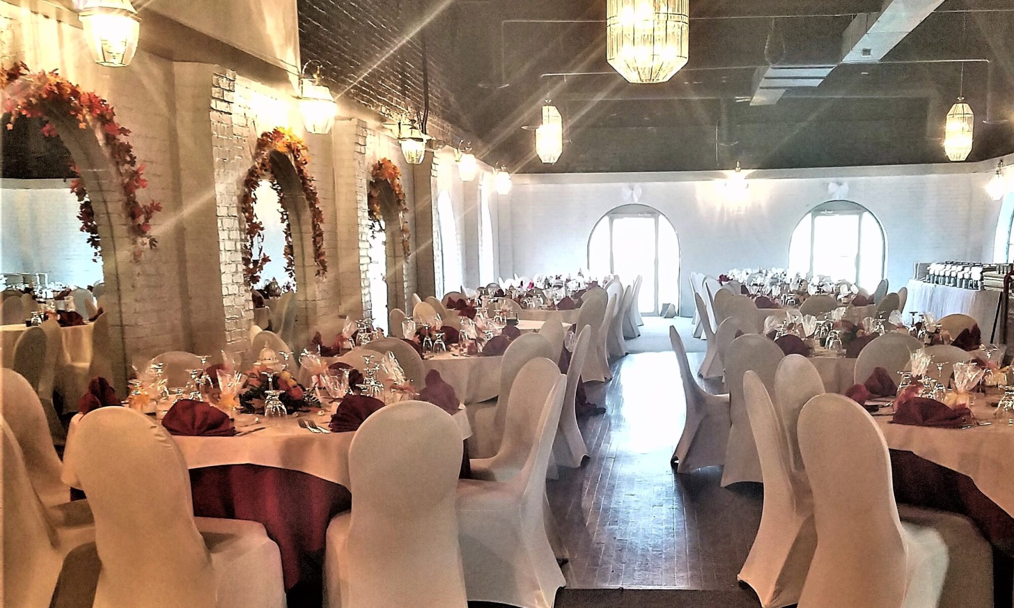 Elegant banquet hall with decorated tables.